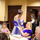 Olivia Pam princess of Aigues Mortes, center, and Prince Jean-Pierre Pichon, right, meet with MicroCon 2017 hostess Queen Anastasia of Ruritania, sitting, during The MicroCon 2017 Gala in Dunwoody, Ga. on June, 24, 2014.
